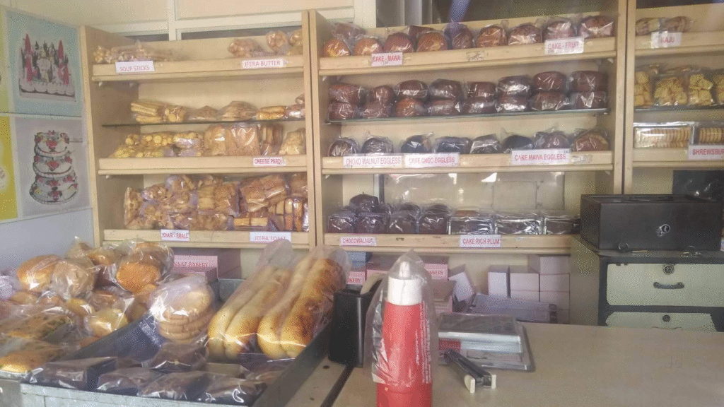 The exterior of Naaz Bakery & Cafe, a classic Irani cafe with wide arches on a corner in Camp, Pune.