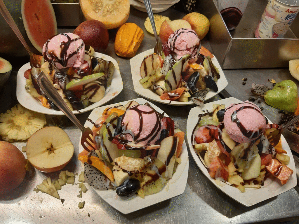 The brightly lit, functional storefront of K.G.N. Bakery in Camp, Pune, known for late-night bakes.